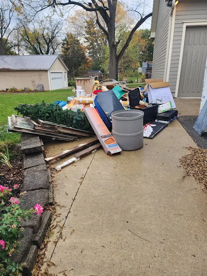 Dumpster being loaded with debris for Roofing Dumpster Rental in Teaneck
